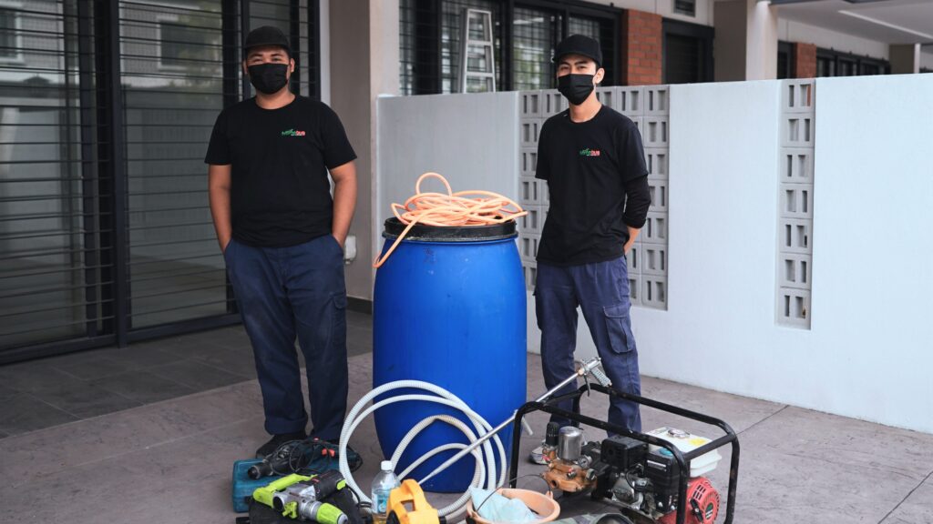 Professional Nomobug pest control team posing confidently in uniform